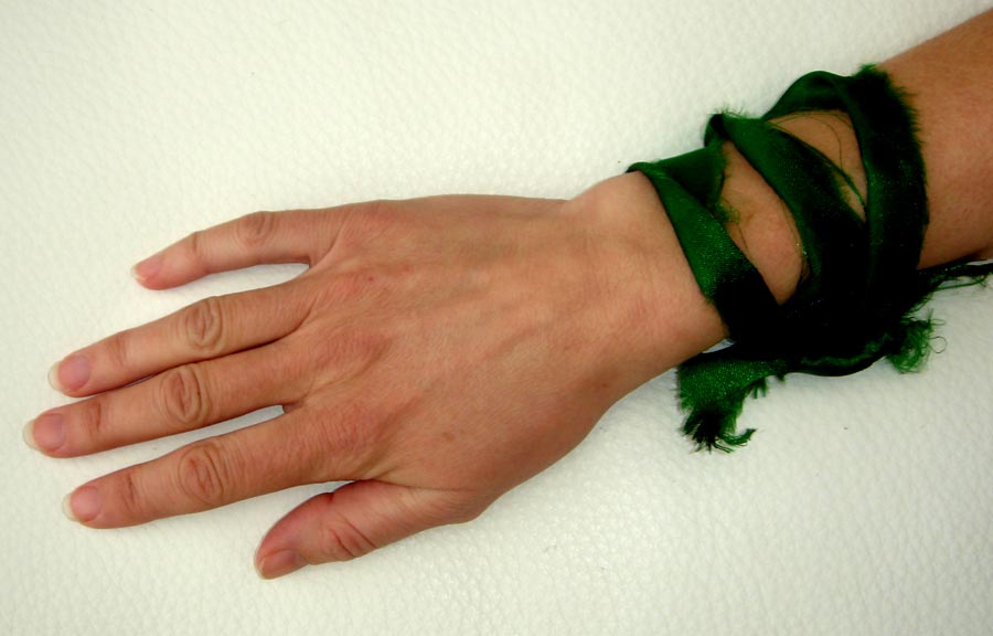 A ribbon tighten around the wrist to protect and benefit its owner. The ribbon has been cut from a piece of fabric which has been rubbed on the sarcophagus at the shrine of al-Abbas in Karbala.